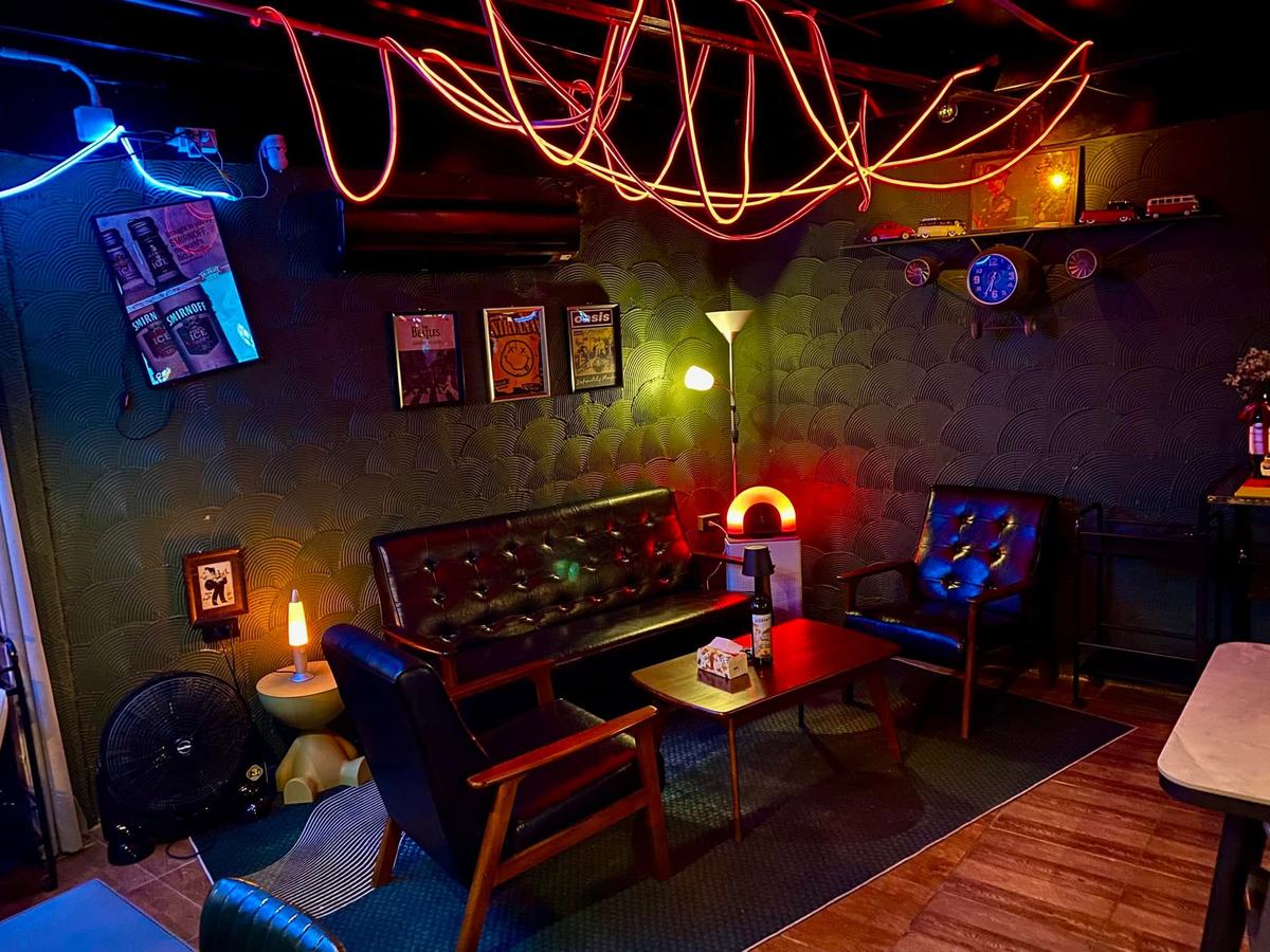 MOOD Bar — leather lounge corner under neon rope lights